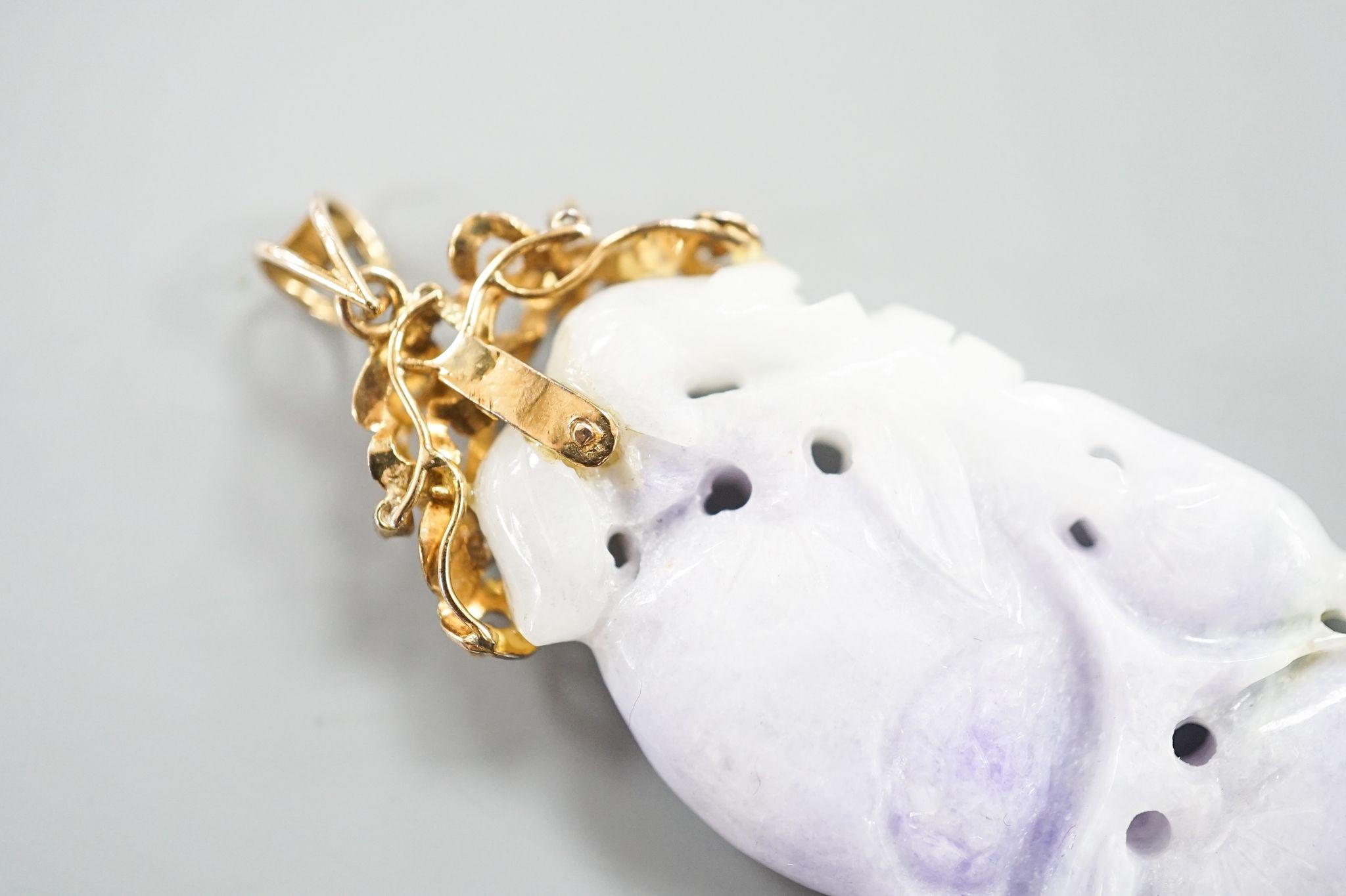 A 14k yellow metal mounted carved jade and diamond chip set pendant, overall 66mm, gross weight 19.4 grams.